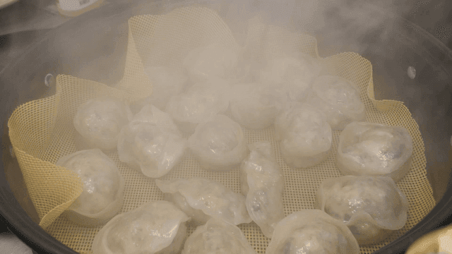 Hot dumplings steaming in steamer