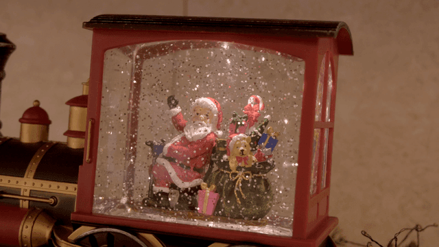 Santa figurine in a snow globe train