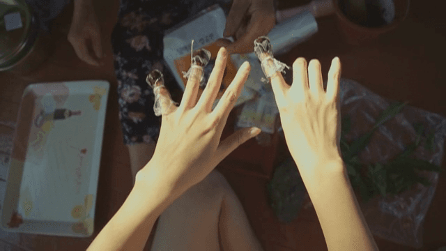 Crushed balsam flower petals placed on a fingernail