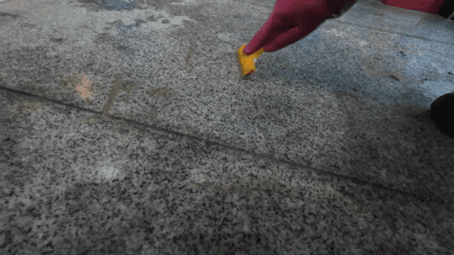 Cleaning tile floors with scraper