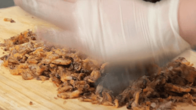 Chopping mussel on a wooden board