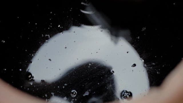 Soy sauce pouring into a jar