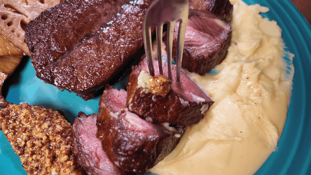 Steak topped with whole grain mustard