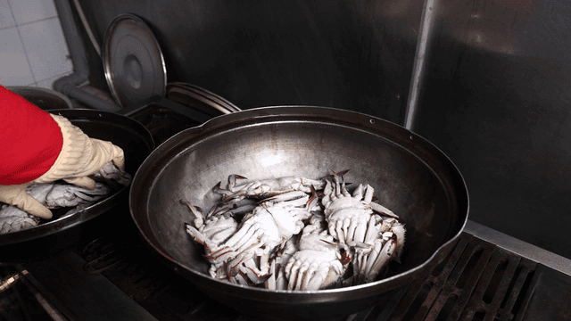 Crabs piling up in pot in kitchen