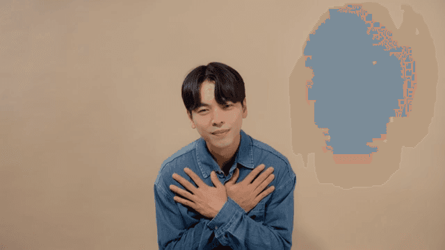 Man expressing gratitude with a sincere smile and hand on her heart