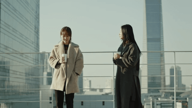 Two women talking on the roof of a company building