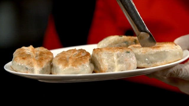 Plate of fried dumplings being served