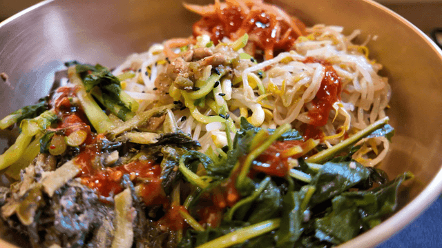 Bowl of colorful bibimbap with vegetables