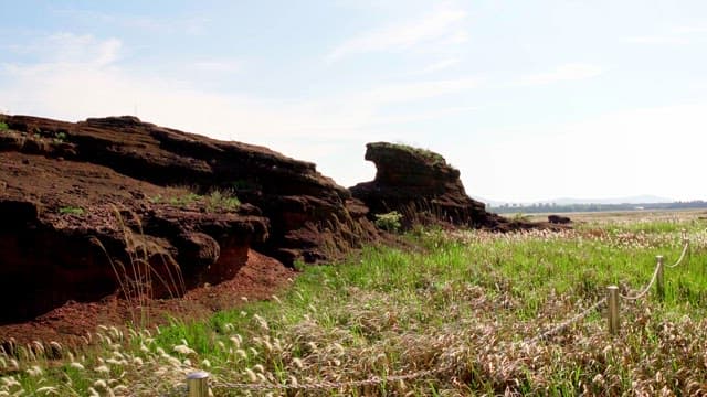 Rocky landscape with green fields