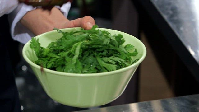 Fresh mugwort with spicy sauce in a bowl