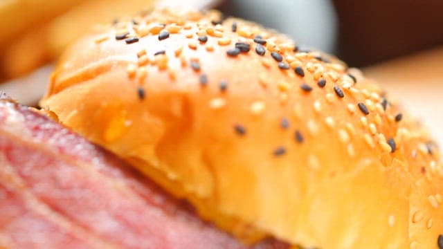 Close-up of a juicy bacon cheeseburger