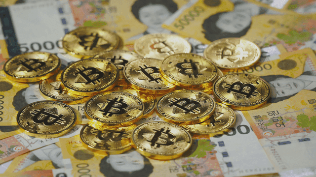 Bitcoin coins on Korean won bills