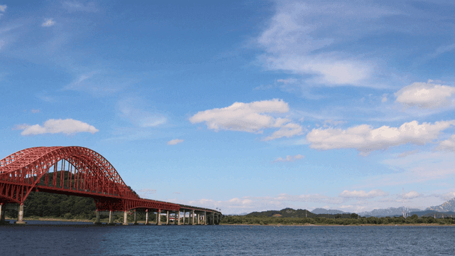 Red bridge over calm river