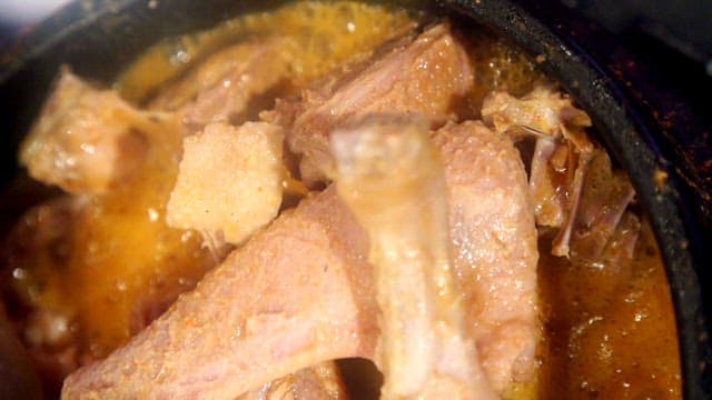 Duck soup boiling in an earthen pot