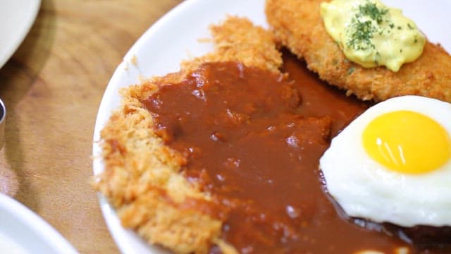 Plate with fried cutlet, egg, and salad