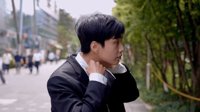 Office worker man checking his watch after fixing his hair and walking down the street