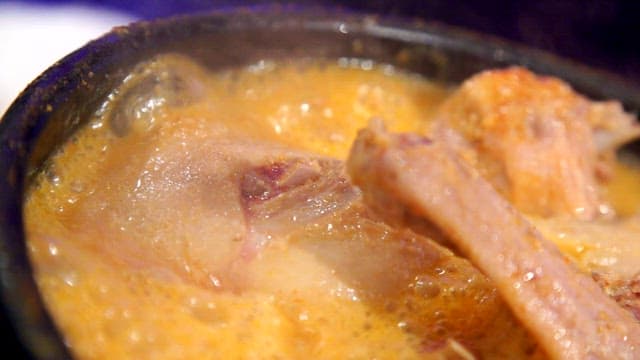 Duck soup boiling in an earthen pot