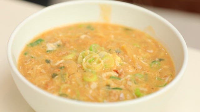 Bowl of thick and delicious ramen with green onions