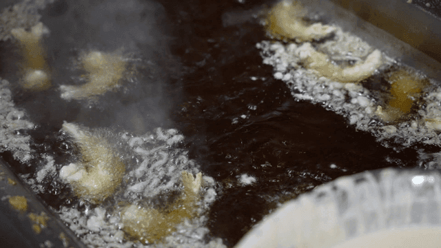 Shrimp being fried in kitchen