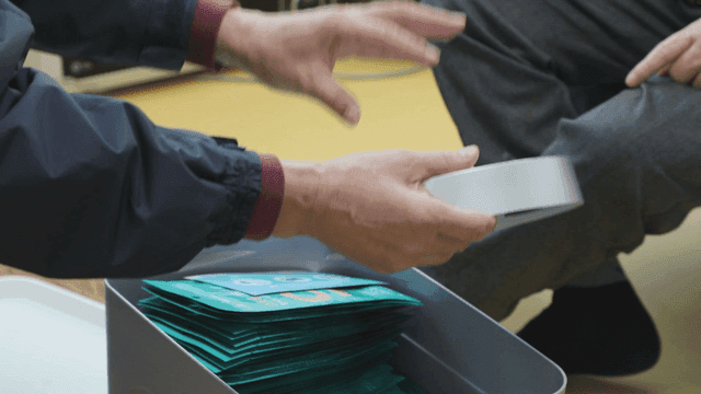 Person holding a clock in house