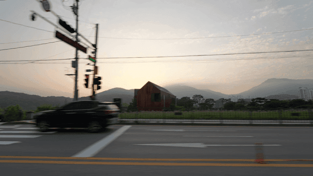 A road with trees and mountains at sunrise