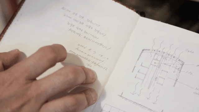 스케치가 있는 노트를 읽는 사람