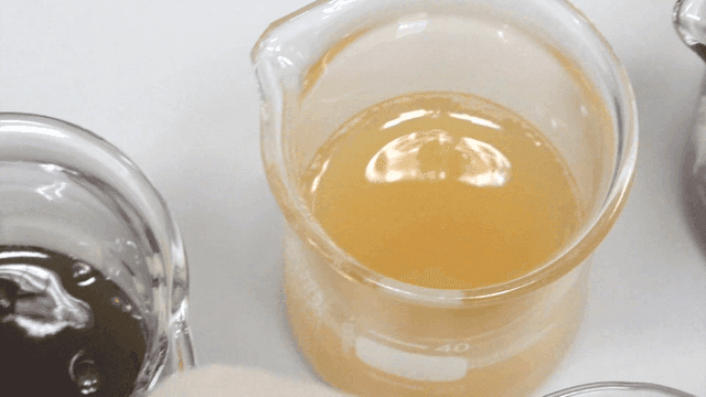 observing varied liquids in a beaker with latex gloves