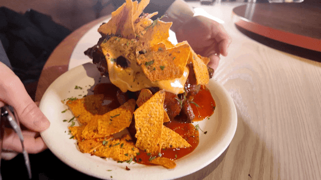 Wood-fired whole chicken topped with nachos served