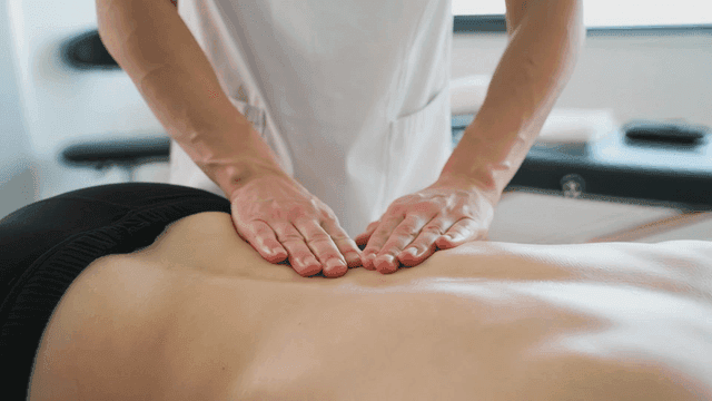 Massage therapist who performs back massages