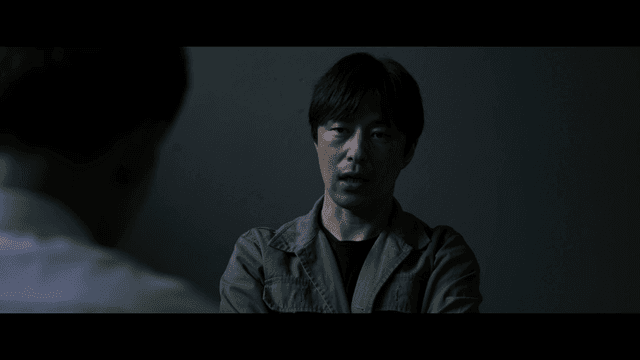 Man interrogating in dark room