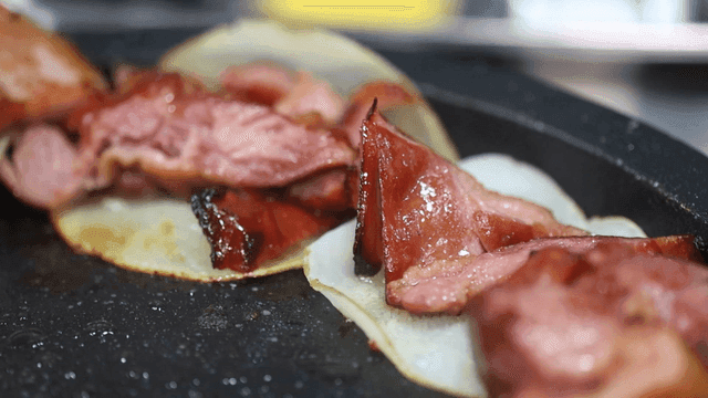 Roast duck sizzling on hot grill