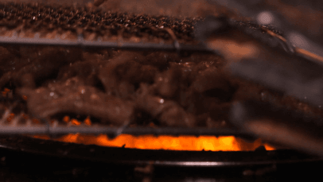 Smoke rising from wire mesh, charcoal briquette bulgogi