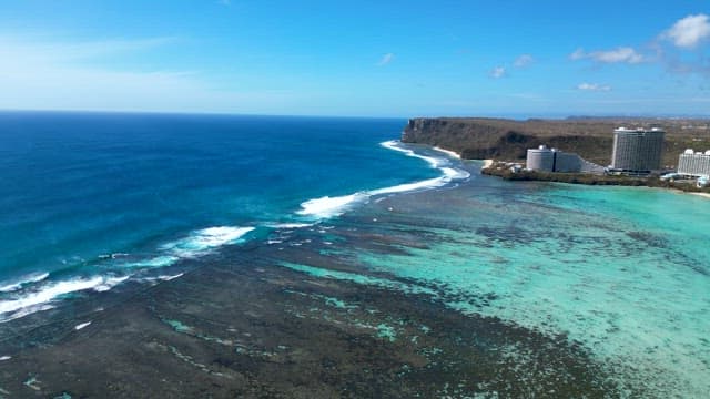 Waves Gently Rolling in Shallow Sea Full of Coral Reefs