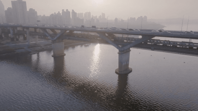 Bridge over a river with city skyline