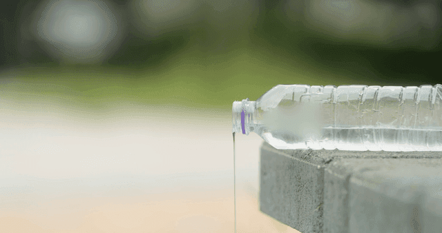 Water bottle pouring on a concrete surface