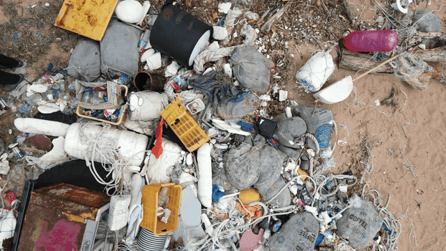 A beach littered with various debris