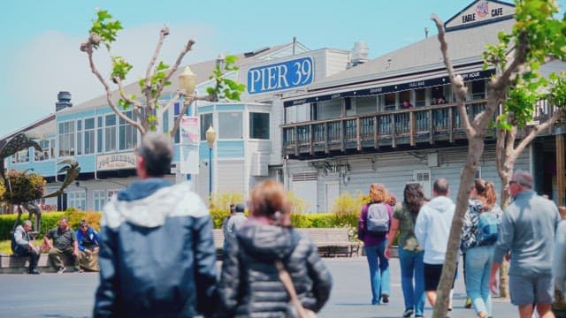 Bustling Pier Marketplace with Tourists on a Sunny Day