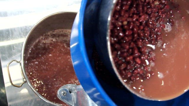 Red beans being poured into a pot