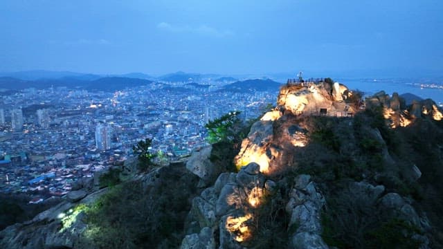 City view from a lit mountain at dusk