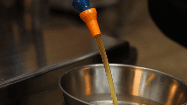 Sesame oil poured into metal bowl