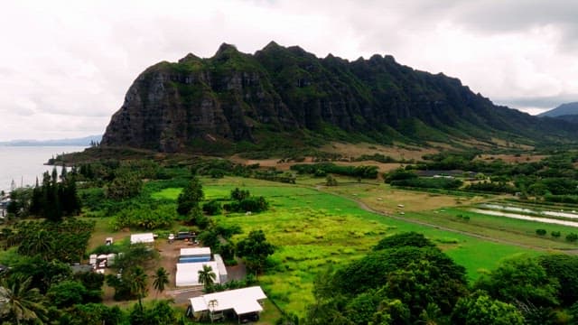 산 절벽 아래 푸른 농지가 있는 마을