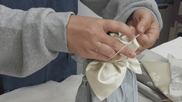 Hand wrapping bottles with traditional cloth