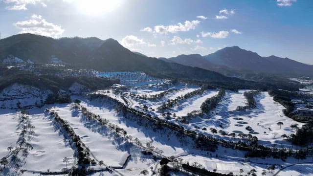 Snow-covered Valley with Mountain Backdrop