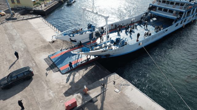 Ferry docked at pier with passengers