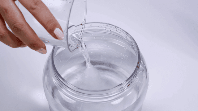 Pouring water into a clear jar