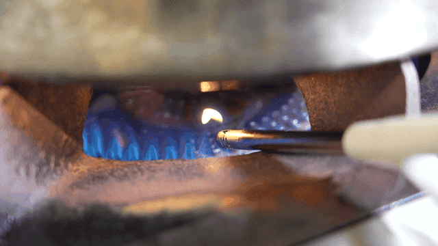 Gas stove being ignited with a lighter