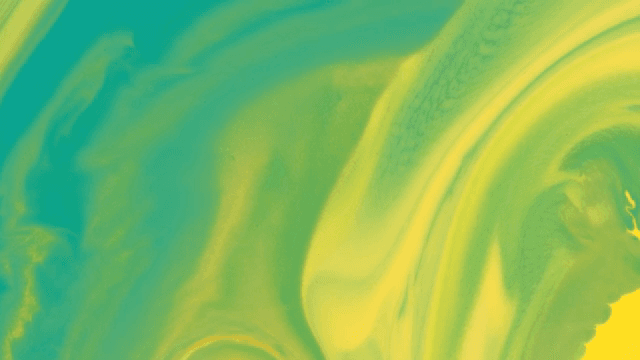 Abstract pattern of green and yellow liquids mixing together