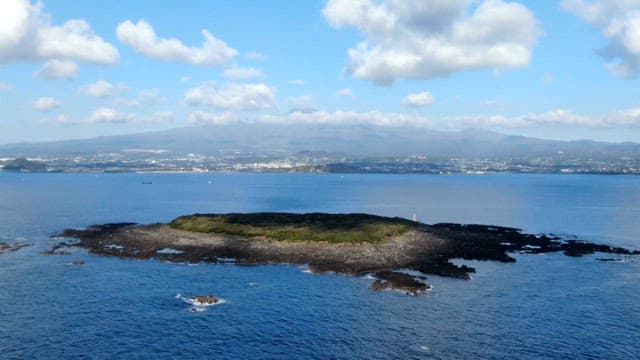 Remote island surrounded by blue sea on a sunny day