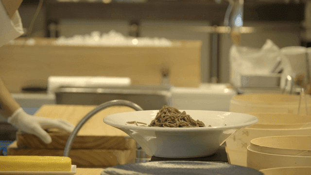 Chef preparing soba noodles in a kitchen