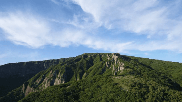 Green mountains under a clear sky